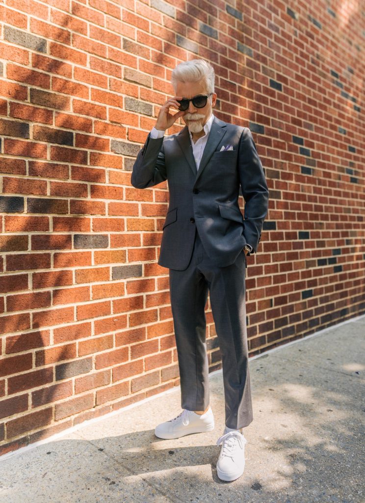 suit with white sneakers