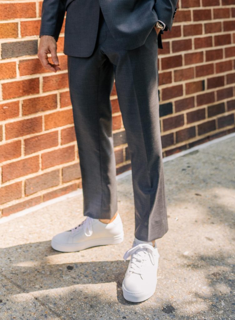 White sneakers with grey suit