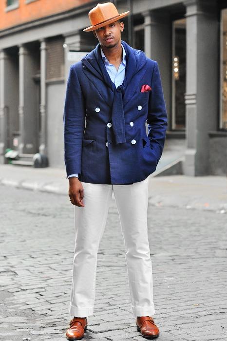 man wearing white chinos, blue coat and hat