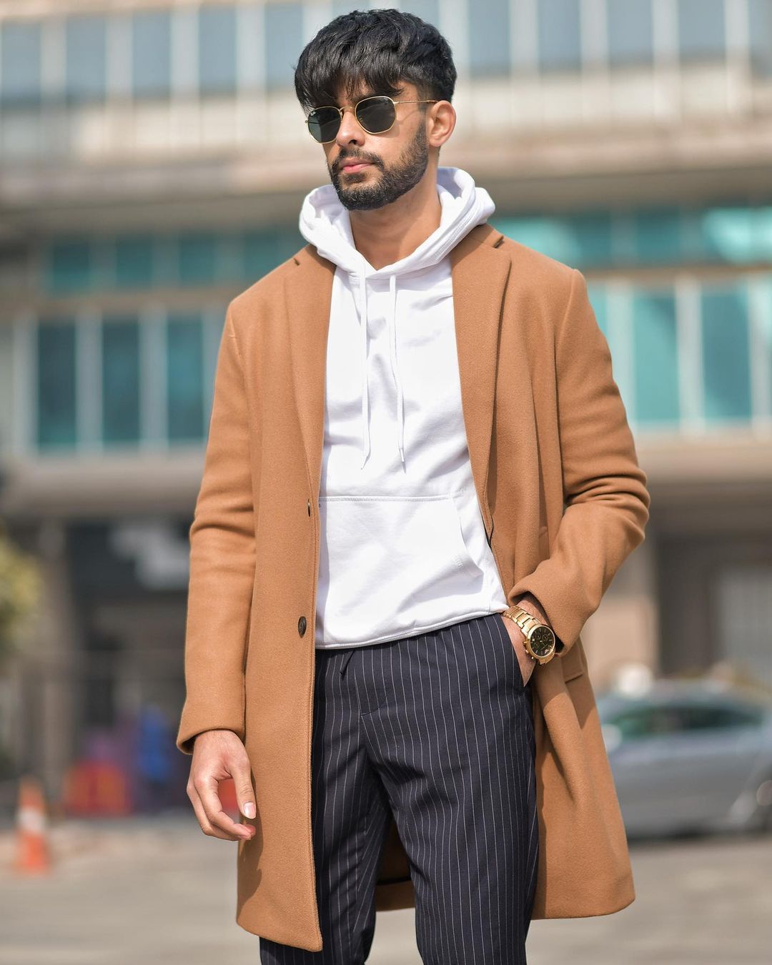 Premium Photo | Portrait of pensive indian man with curly hair wearing  stylish jacket looking away on the street