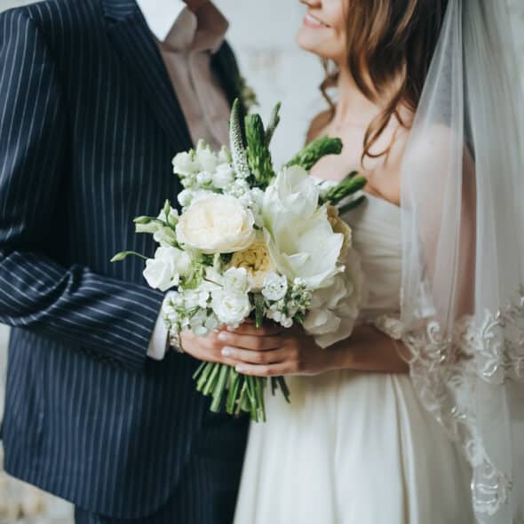 Bride and groom holding bouquet