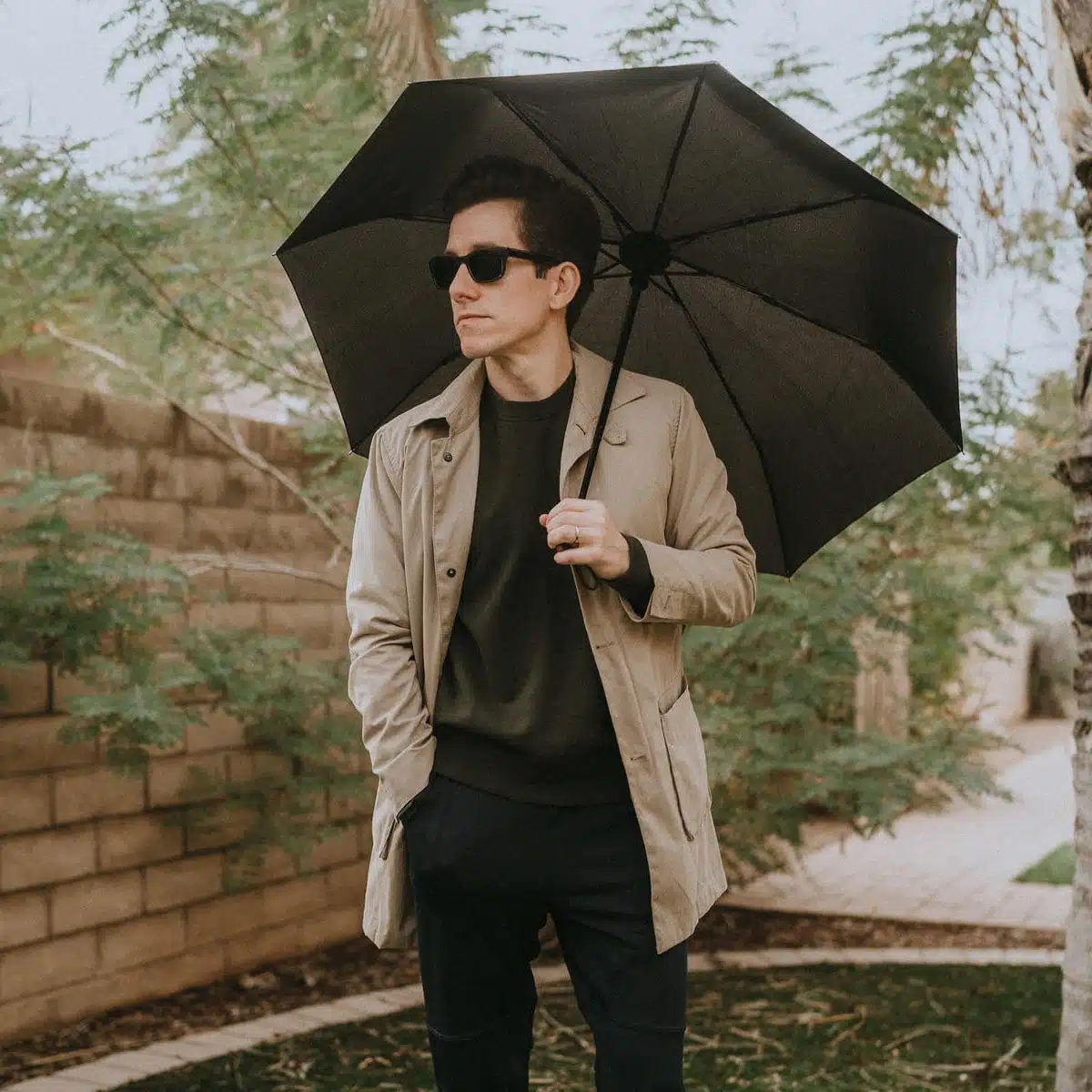 Brock in a Raincoat holding an Umbrella