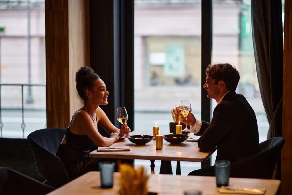 Happy couple in elegant attire holding glasses