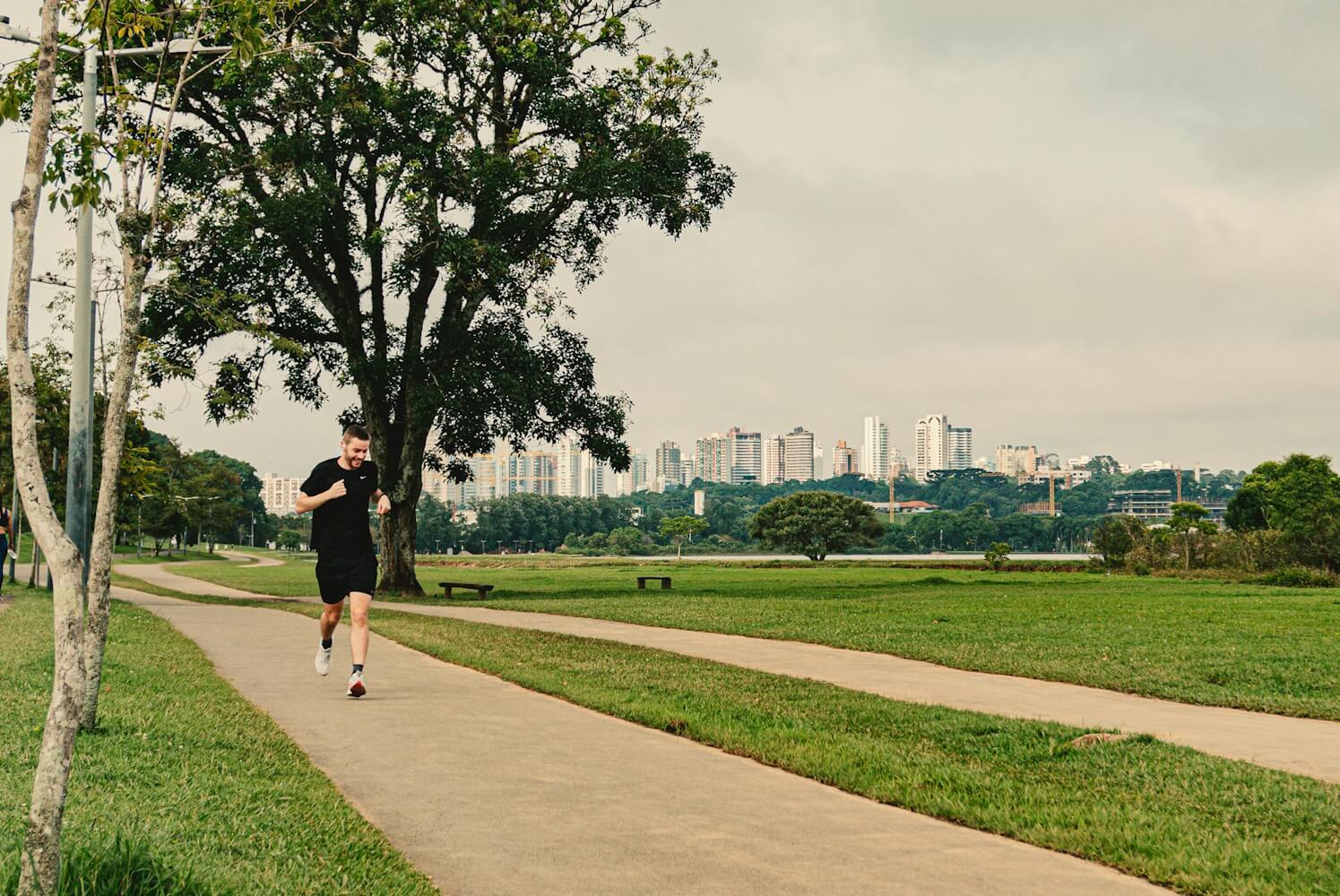 A man jogging on a track in a park