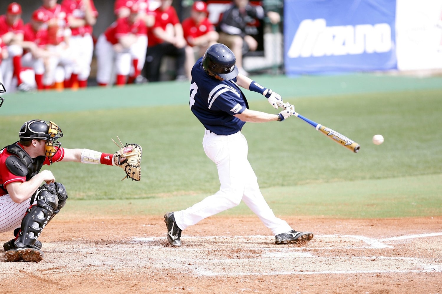 A baseball batter hitting the ball.