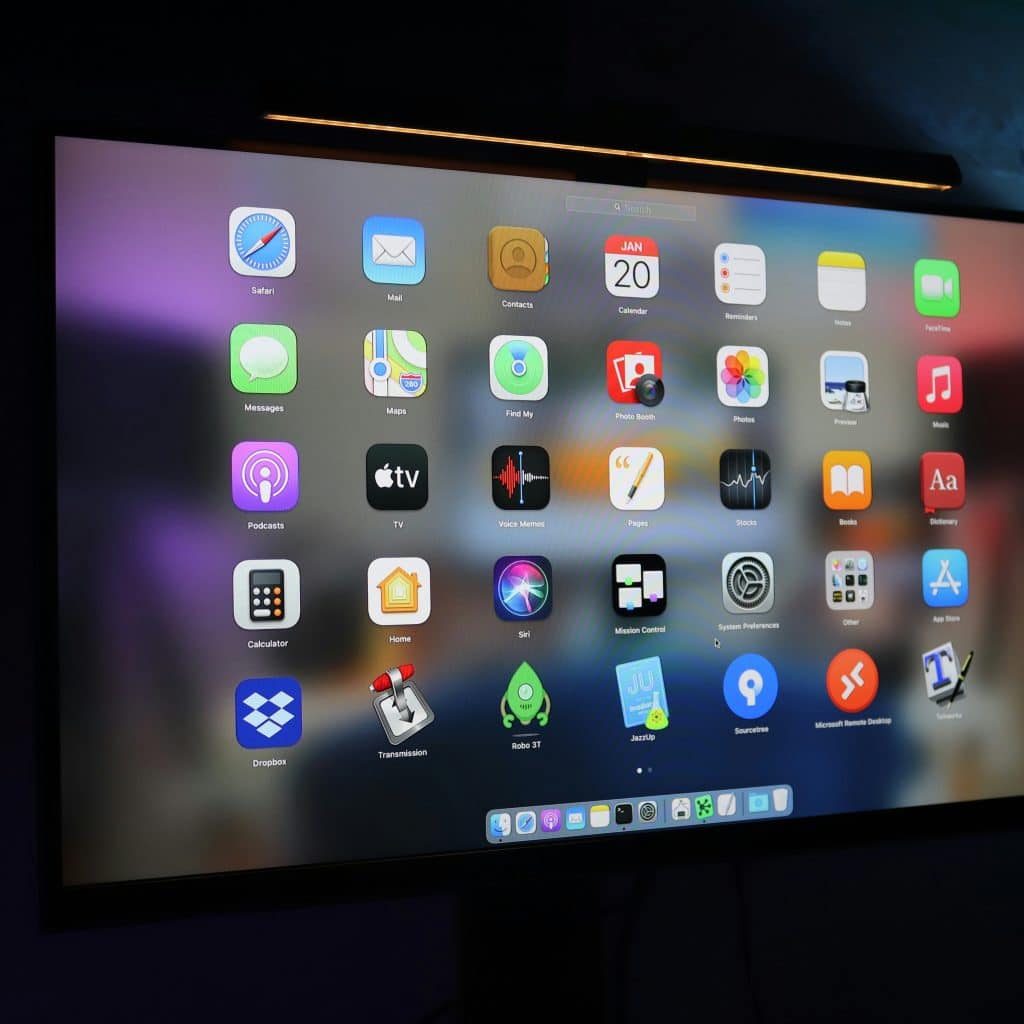 A large screen displays a variety of application icons, suggesting a range of software tools.