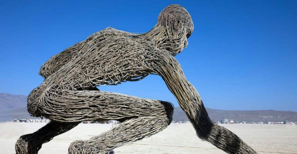 A large wooden sculpture in the desert at Burning Man.