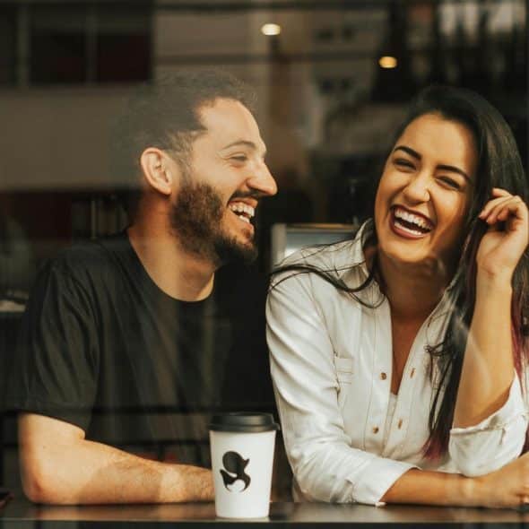 Couple Laughing in a Cafe