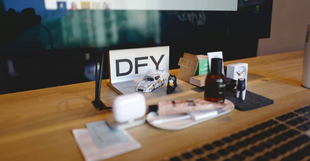 A work desk with various items including grooming products, a small toy car, and office supplies.