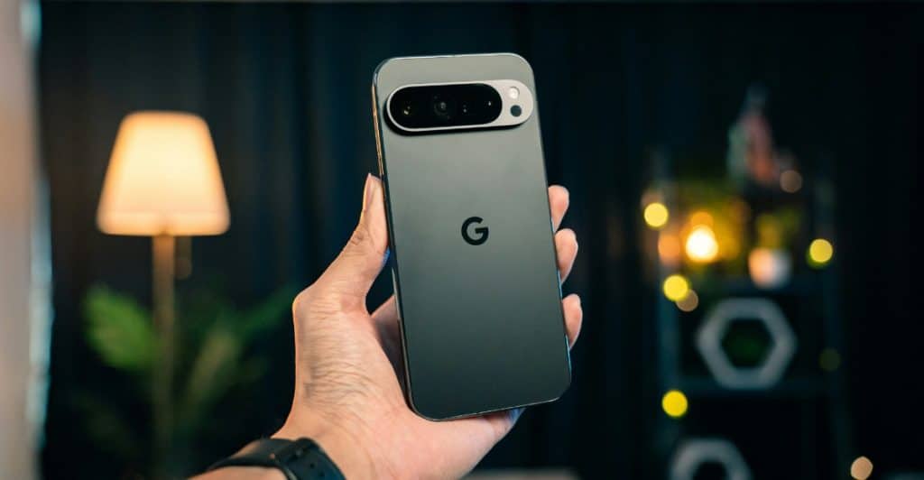 A hand holding the Google Pixel 9 Pro in black.