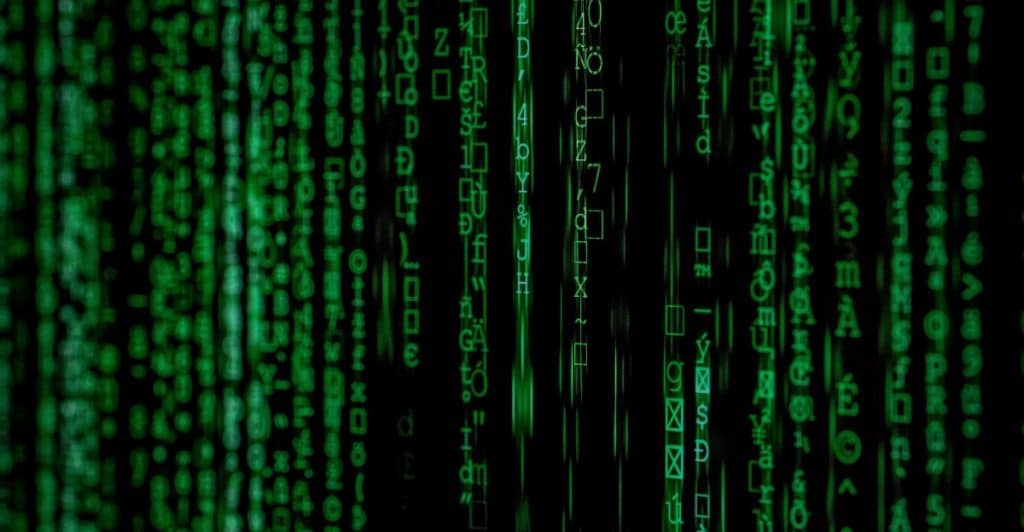  Green lines of computer data cascade down a black background.