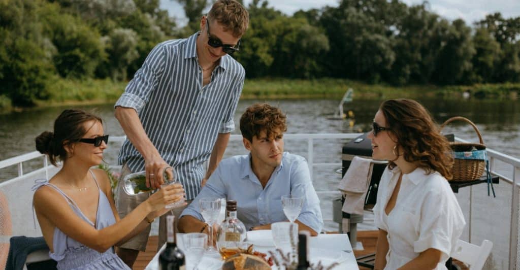 A group of friends enjoying a meal together at a table outdoors.