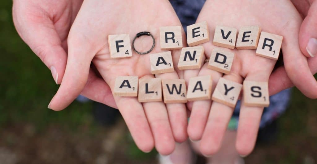 "Forever and Always"Alt-text: Close-up of two people holding puzzle pieces that spell out "FOREVER AND ALWAYS."