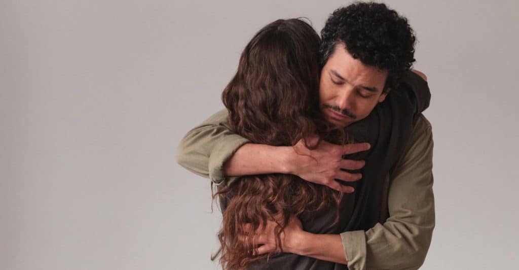 Man hugging a woman tightly