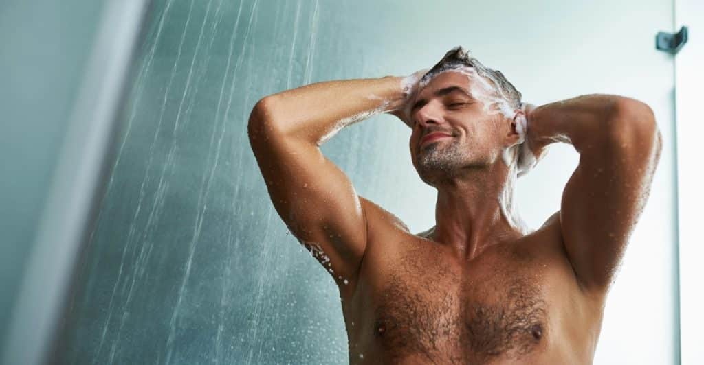 A medical professional in a lab coat is holding a clipboard and appears to be consulting with a patient.