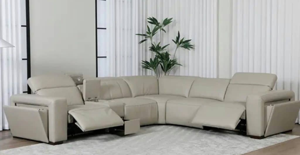 A modern, light-colored sectional sofa in a living room.