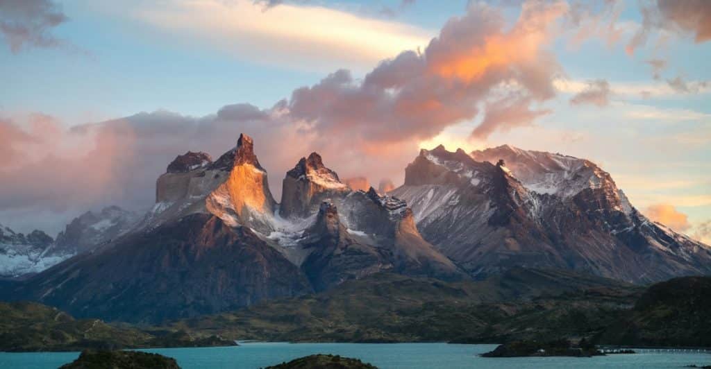 Clouds Covering Snowcapped Mountain Peaks at Sunset.