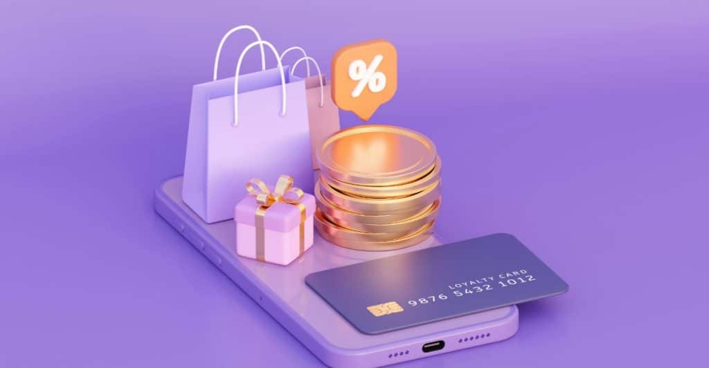 Phone with shopping bags, gift, coins, and loyalty card on it.