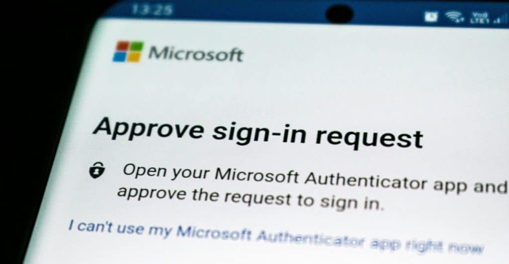 A close-up of a smartphone screen displaying a Microsoft sign-in request with an authentication prompt.