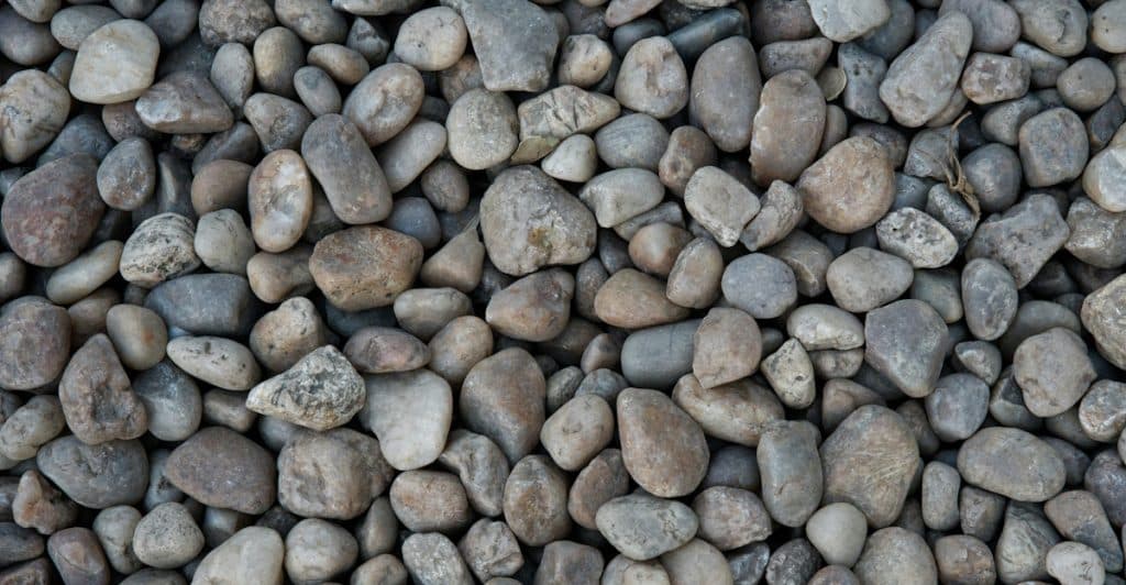 A close-up, textured shot of small, smooth stones.