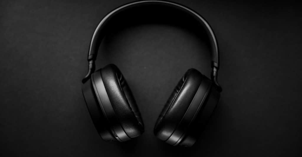  A top-down view of black Sony WH-1000XM5 headphones against a dark background.