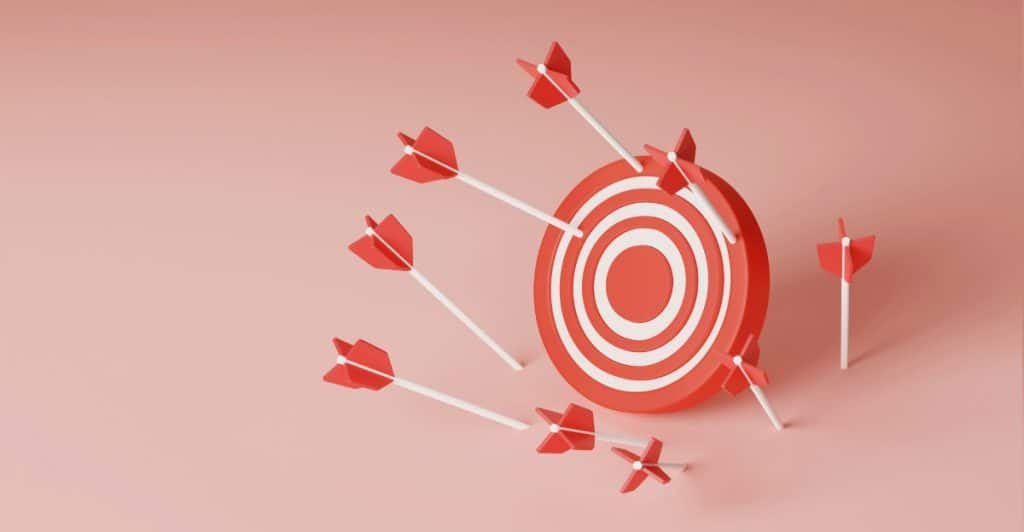 Several arrows hitting and missing a red and white target.