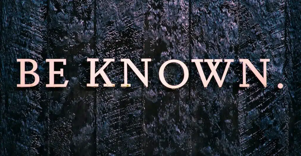 The words "BE KNOWN." spelled out in three-dimensional, light-colored block letters on a dark, textured surface.