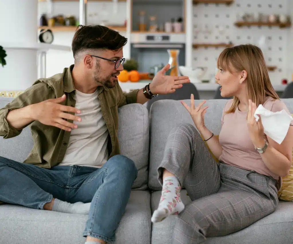A couple arguing in the living room.