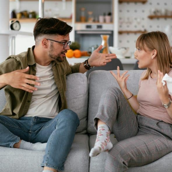A couple arguing in the living room.