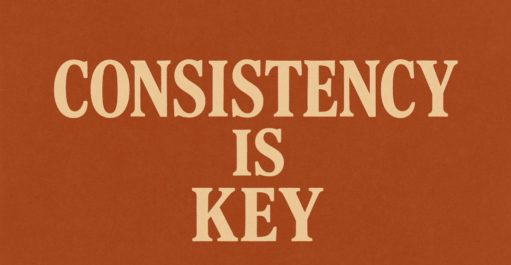 A close-up image of a textured orange background with the words "CONSISTENCY IS KEY" in large, light-colored letters.
