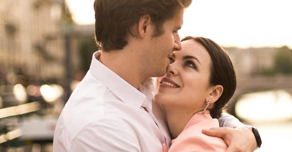 Couple hugging each other while talking, choosing presence over distraction.