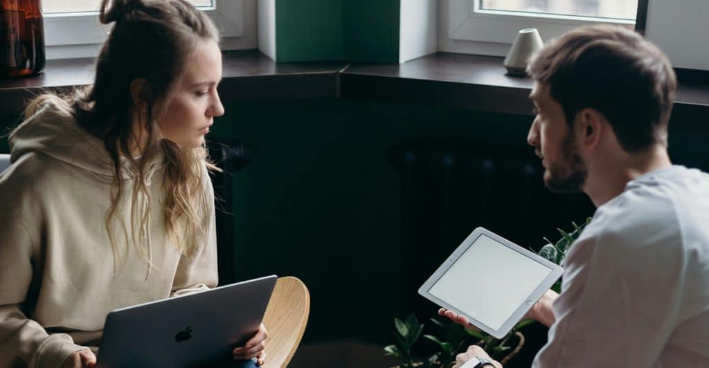 A couple casually reviewing finances together at home.