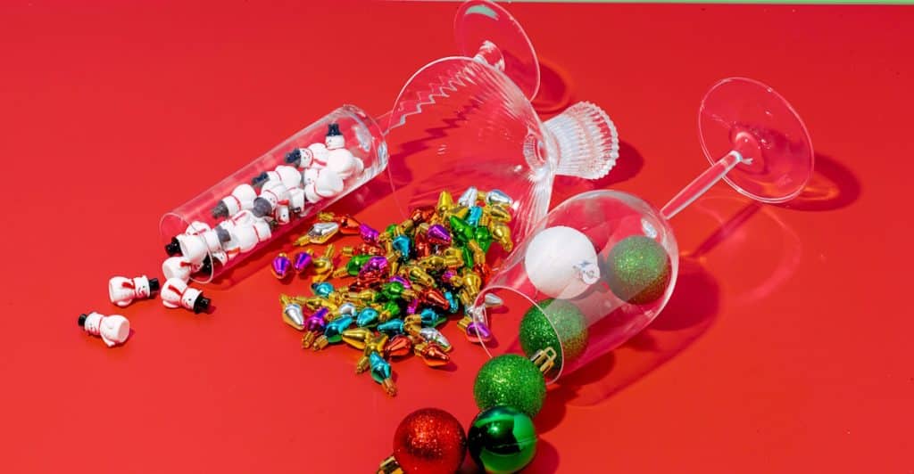 Glasses with confetti and decorations, suggesting the end of a party.