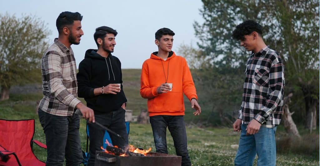Men greeting each other in a hands on social club environment.