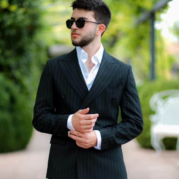 A man looking at a distance reflecting quietly with a thoughtful expression.