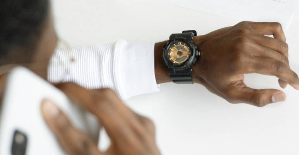 A man checking his phone’s screen time summary, realizing how much time he spends online.