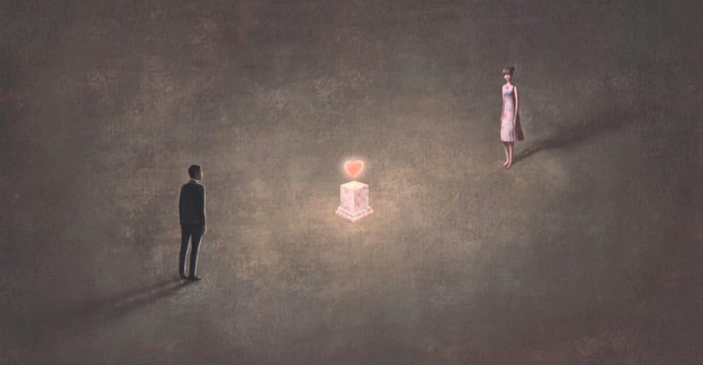 A man and a woman standing far apart from each other with a large glowing red heart between them.