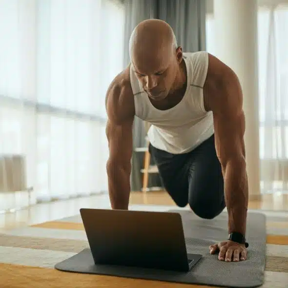 A man with dark hair and a beard is exercising outdoors, wearing a smartwatch on his left wrist, with his eyes closed and his head tilted back.