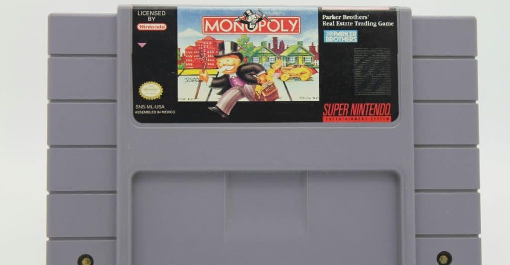 A Super Nintendo Entertainment System cartridge for the game Monopoly, featuring characters and game elements on the label.