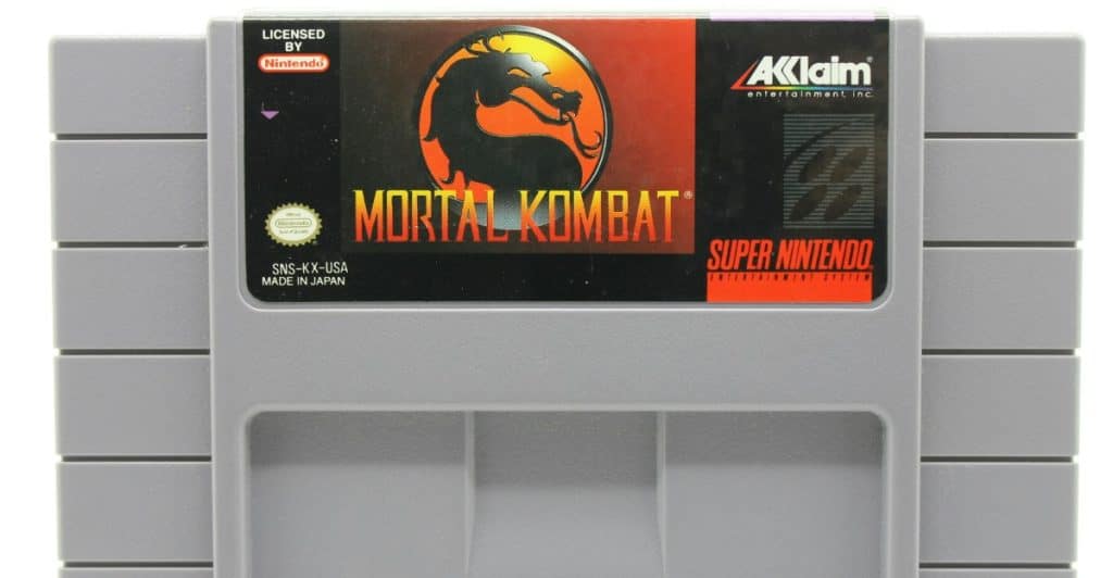 A Super Nintendo Entertainment System cartridge for the game Mortal Kombat, displaying the dragon logo on the label.