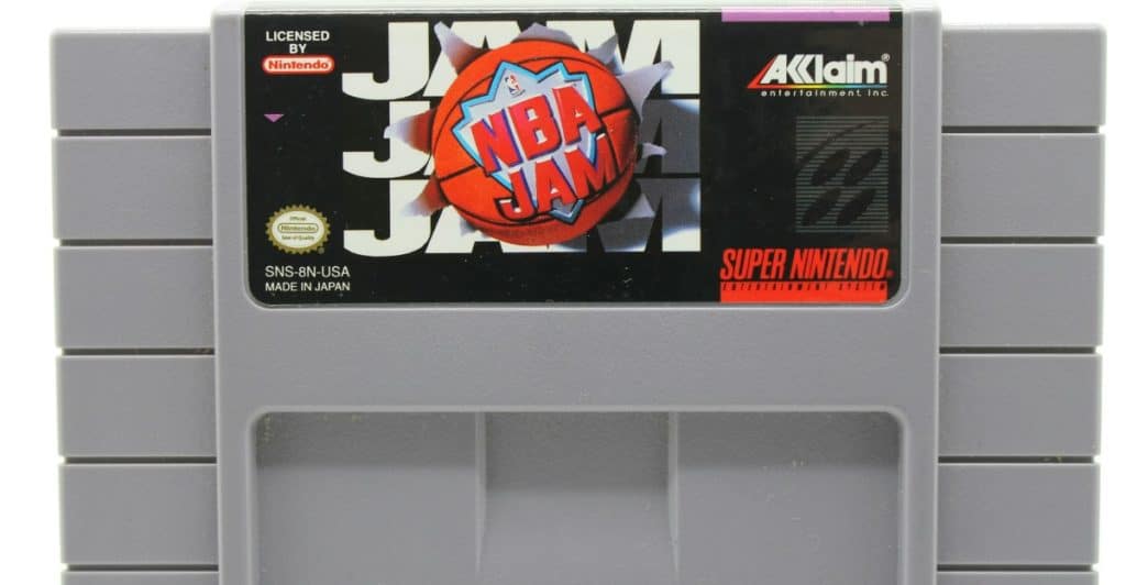 A Super Nintendo Entertainment System cartridge for the game NBA Jam, with a basketball and flame design on the label.