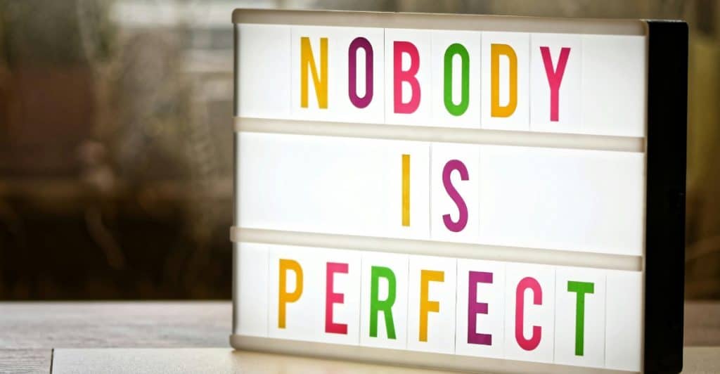 A light-up sign displaying the words "NOBODY IS PERFECT".