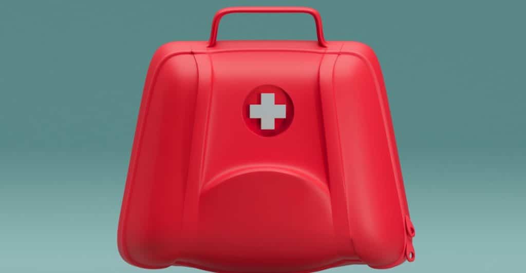 A compact, red first aid kit with a white cross symbol depicted against a teal background