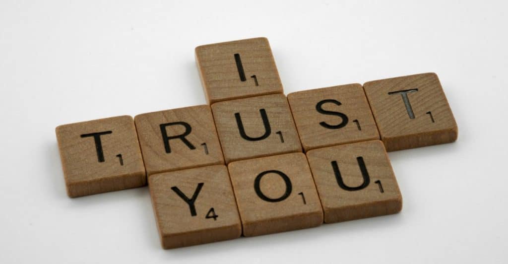 Scrabble tiles arranged to spell the words 'I TRUST YOU'