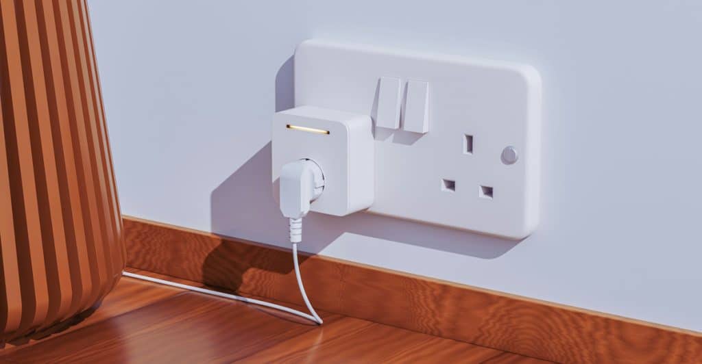 A white smart plug inserted into a wall outlet with a cord plugged into it.