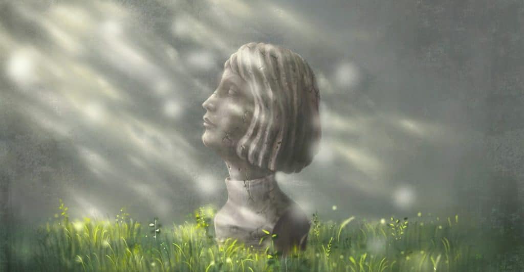 A stone bust of a person's head and shoulders rising out of a field of green grass with light rays.