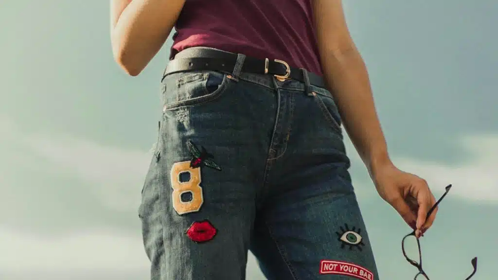 A man wearing a jeans with designs.