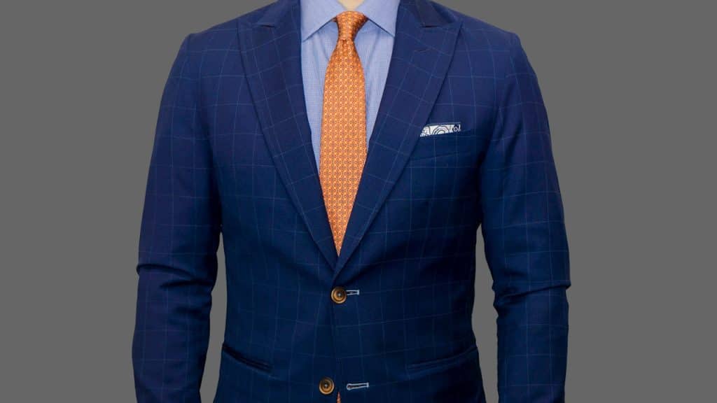 A man wearing a blue blazer and yellow tie.