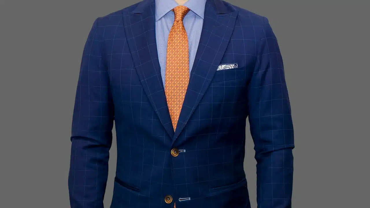 A man wearing a blue blazer and yellow tie.