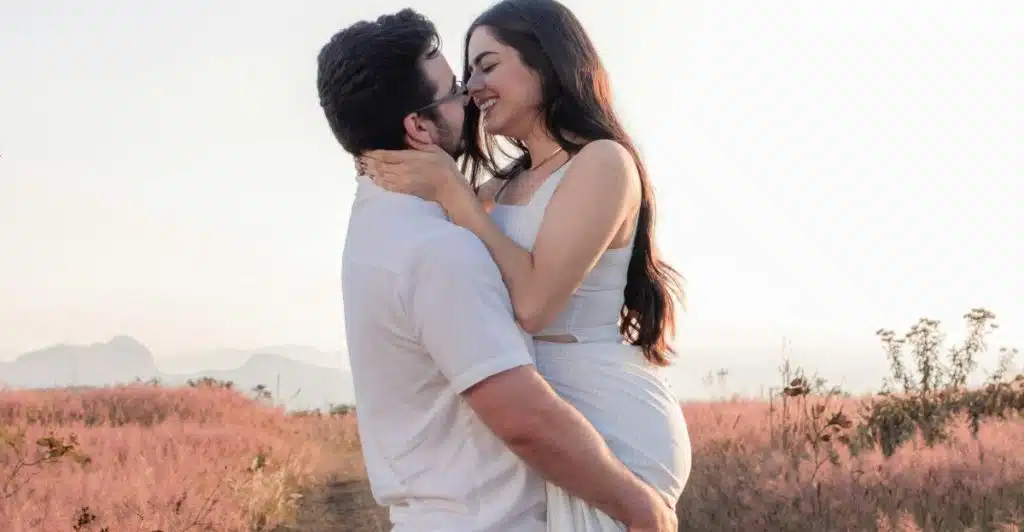 A couple embracing in the evening light, engaged in a calm, emotionally connected moment.